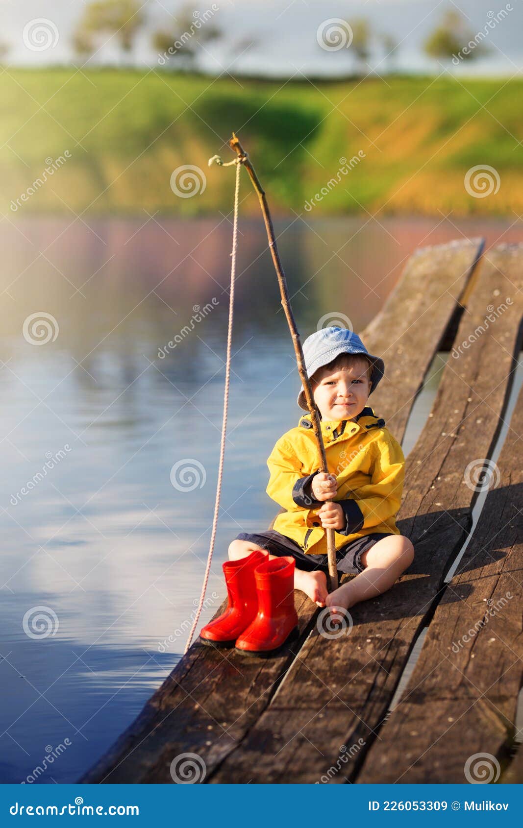 Boy on Wooden Dock with a Fishing Net Stock Image - Image of