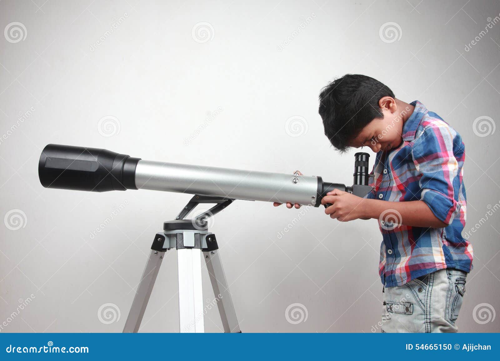 Boy works on a telescope stock photo. Image of background 54665150