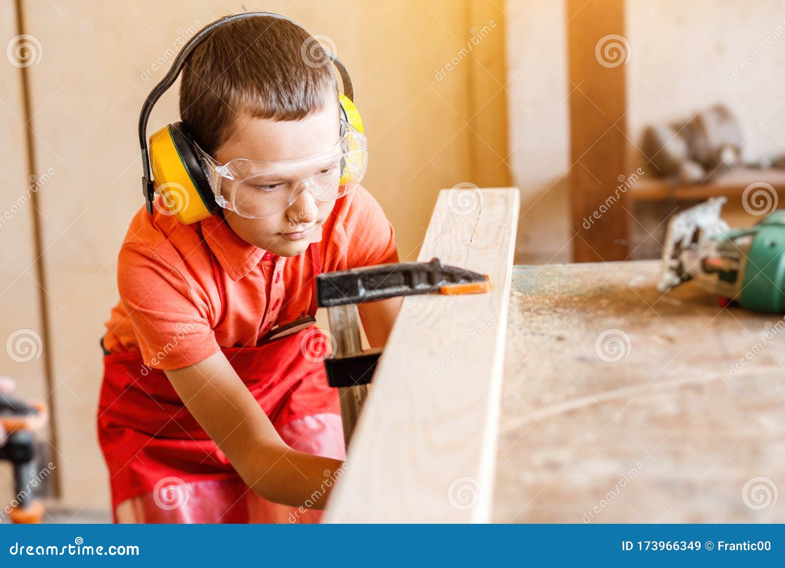 boy in the workshop independently learns to work