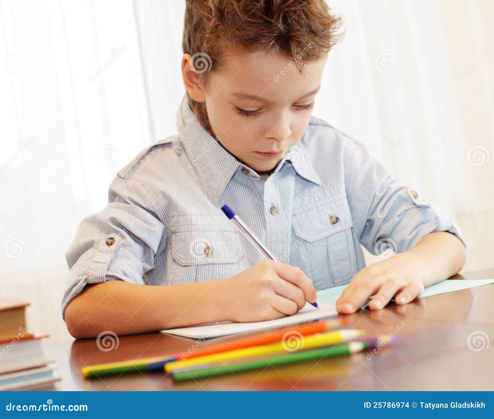 Boy writing in notebook stock photo. Image of people - 25786974