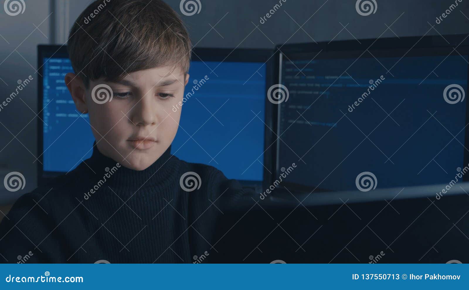 Boy Wunderkind Hacker Hacks Computer Systems. in Data Center Stock