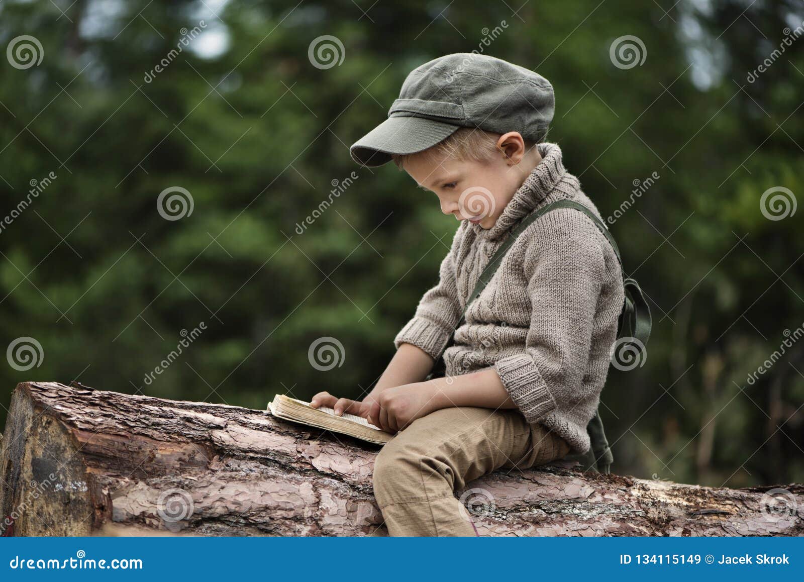 the boy, 5 years old, looks like a trapper, wanderer, lumberjack.
