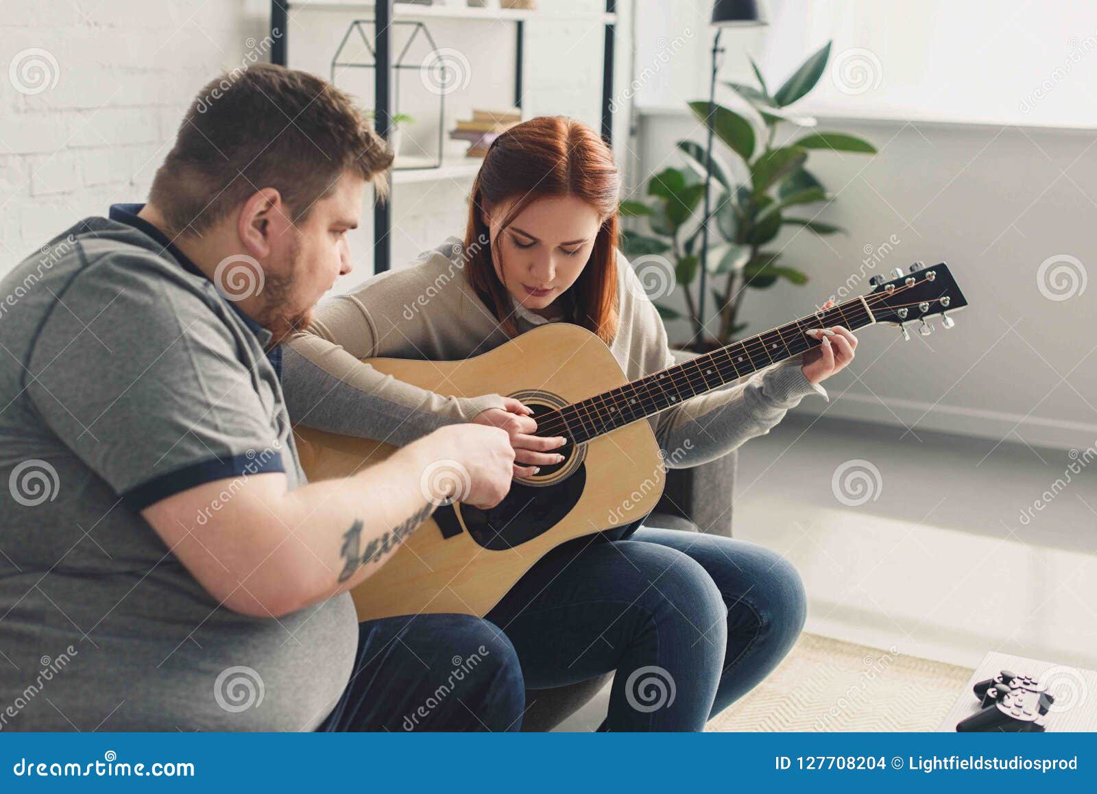 Boyfriend Teaching Girlfriend Playing Acoustic Guitar Stock Photo
