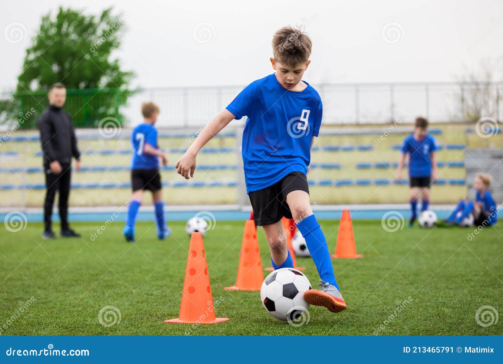 Coach Is Coaching Children Training In Soccer Team Stock Photo, Picture and  Royalty Free Image. Image 65309590.