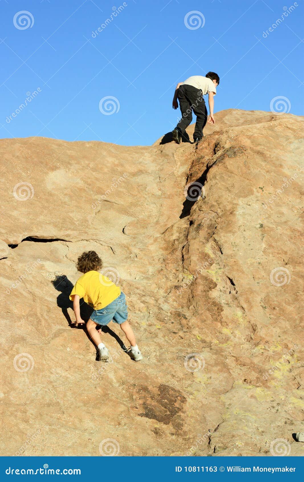 Boys climbing on rocks stock image. Image of children 10811163