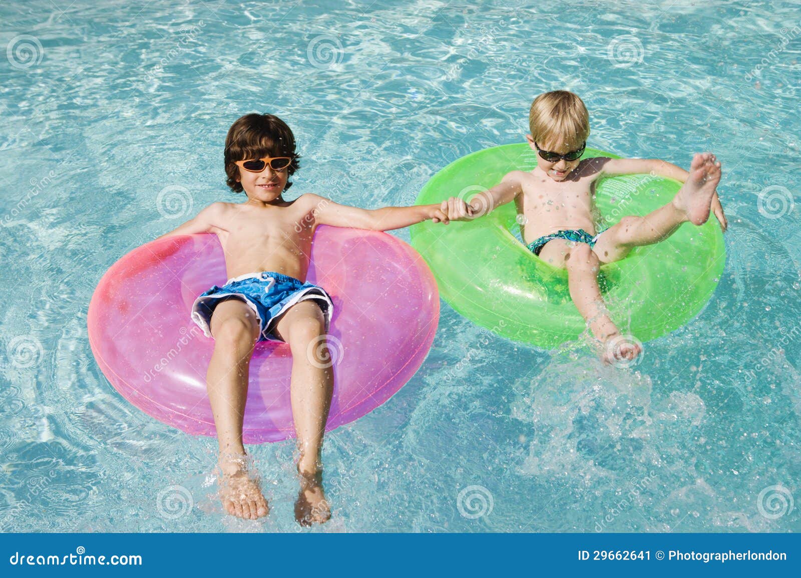 Boys on Float Tubes in Swimming Pool Stock Image - Image of