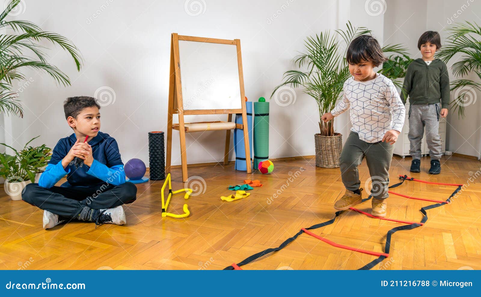 Boys Jumping Over Ladders stock photo. Image of child 211216788