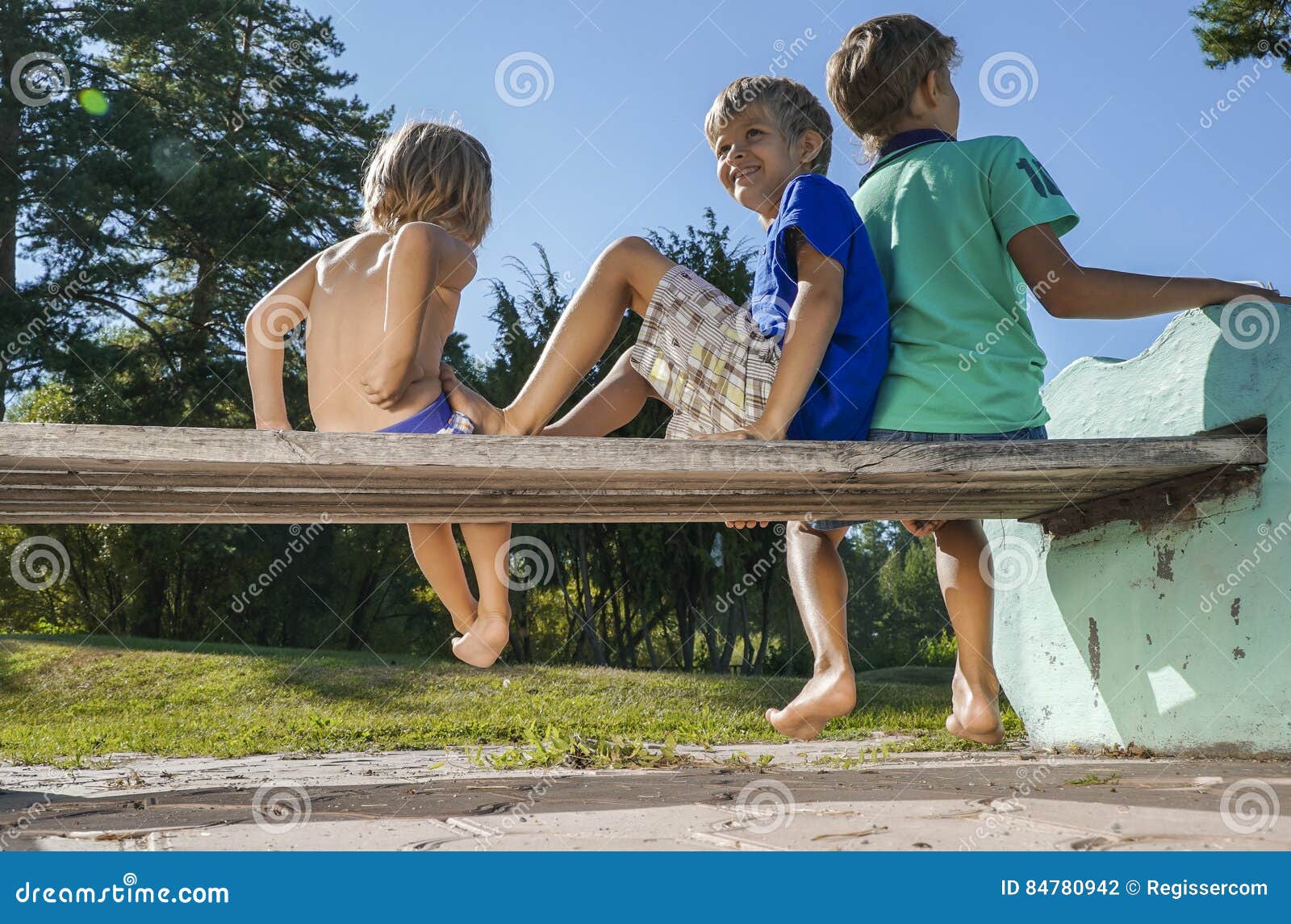 Boys Sitting on the Bench in the Park Stock Photo Image of rear