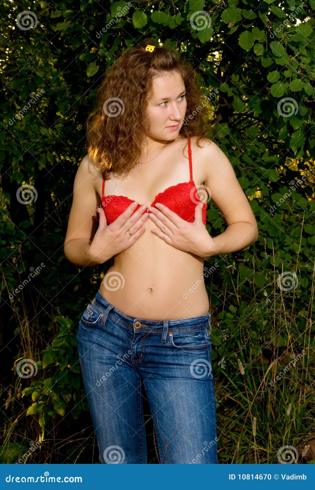 Beautiful woman adjusting her bra Stock Photo - Alamy