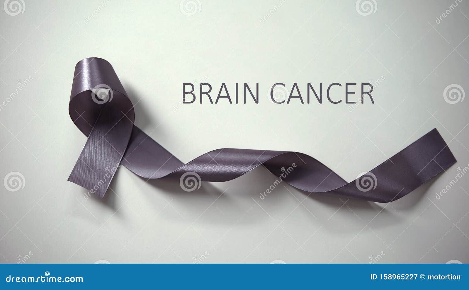 brain cancer inscription, gray ribbon lying on table, awareness campaign, ad