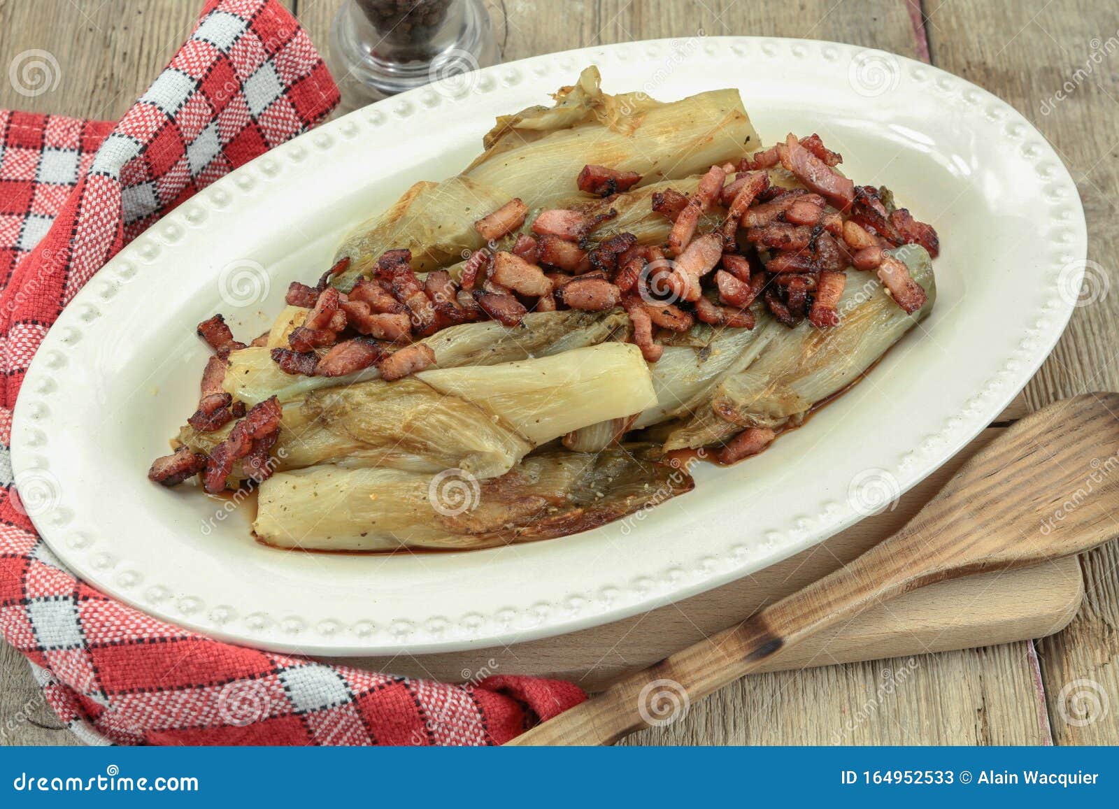 Braised endives with bacon stock image. Image of bacon 164952533
