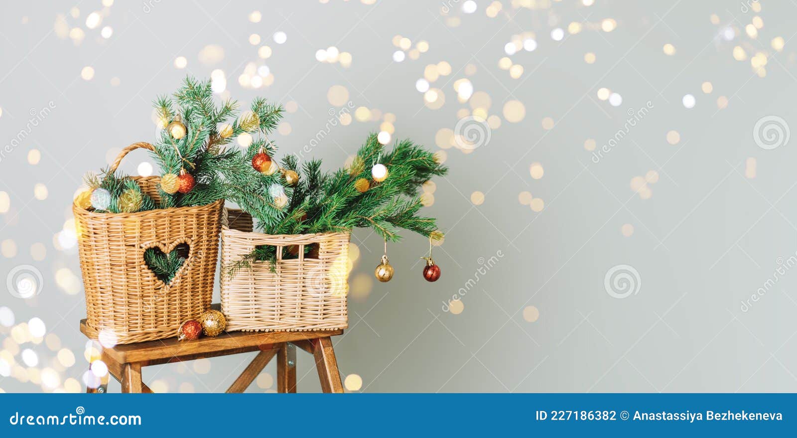 Branches of Christmas Tree with Bauble in Wicker Baskets on Wooden