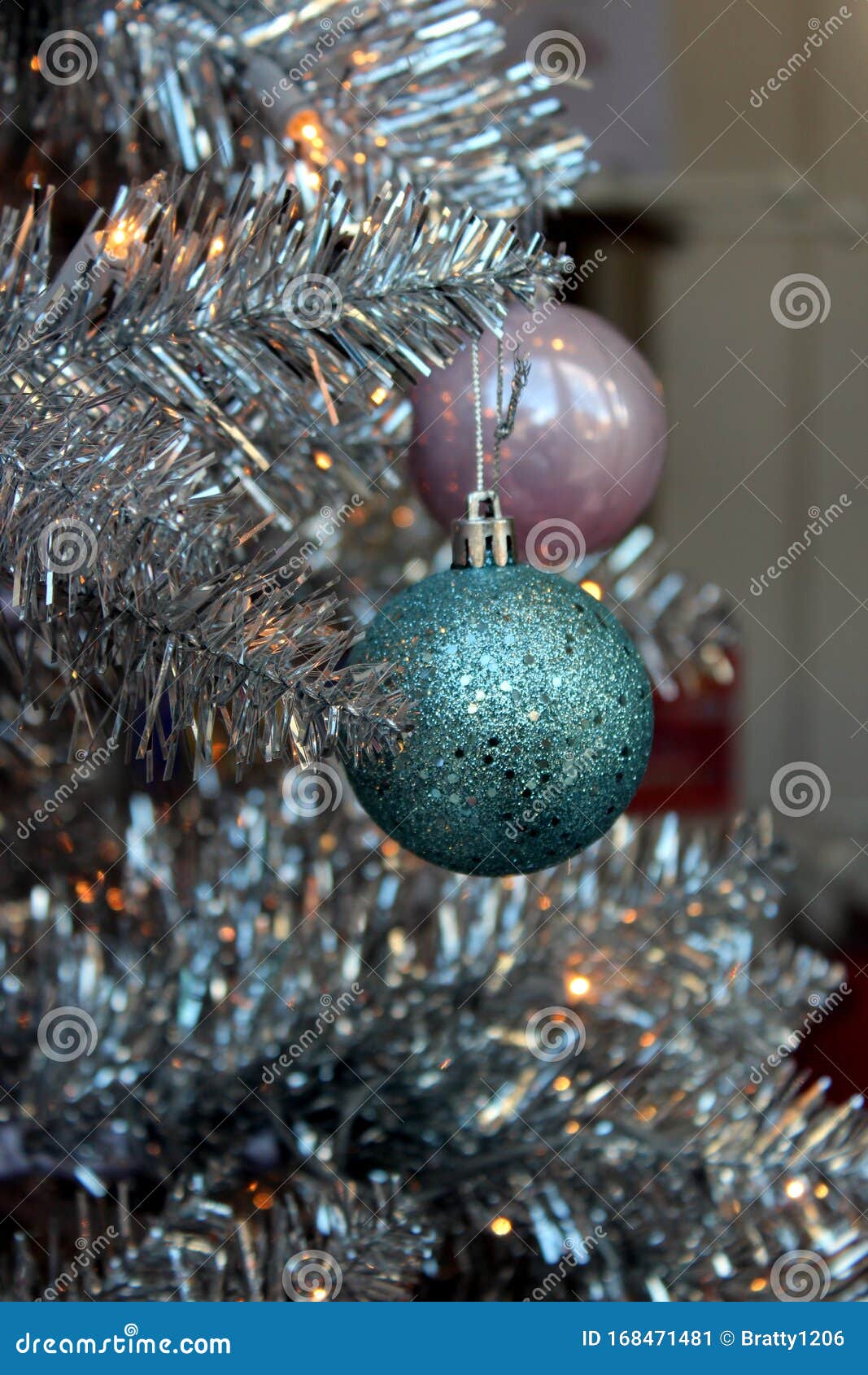 Branches Of Silvery Christmas Tree With Pink And Blue Ornaments Hanging ...