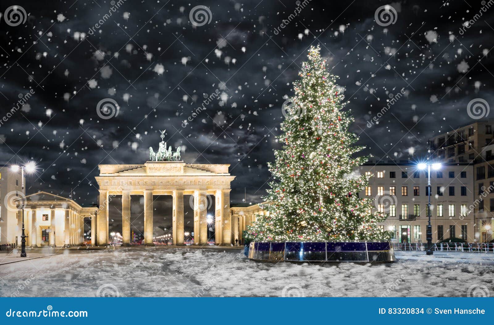 brandenburg gate in berlin, with christmas tree and snow