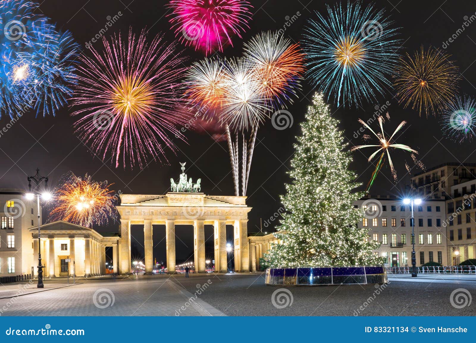 brandenburg gate in berlin, with fireworks and christmas tree