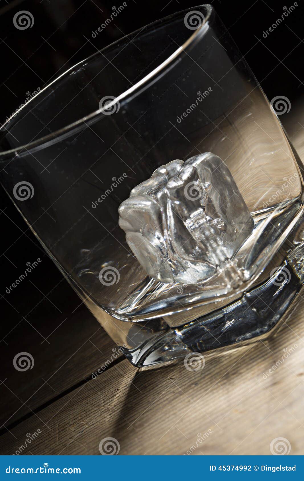 Brandy glass with ice cube stock photo. Image of rock 45374992