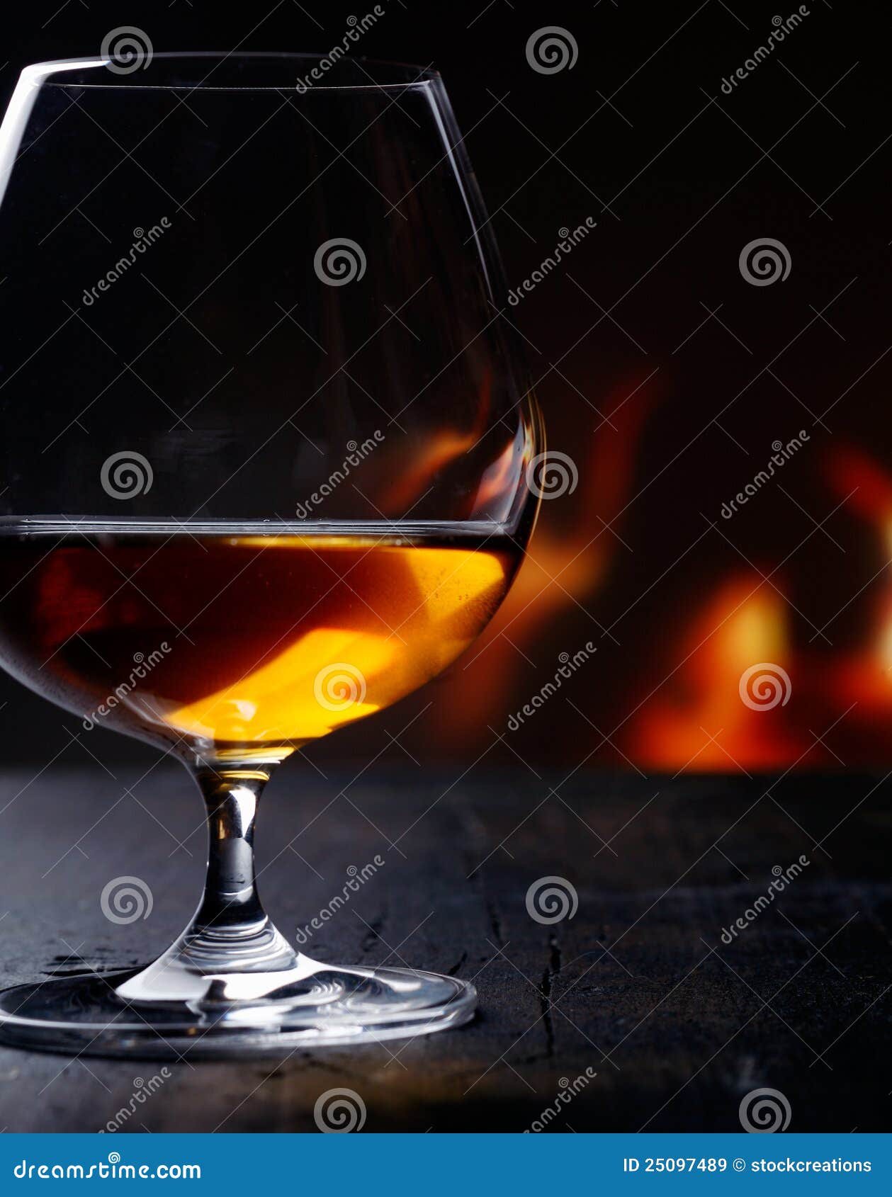 Brandy Snifter Warming before a Glowing Fire Stock Image Image of