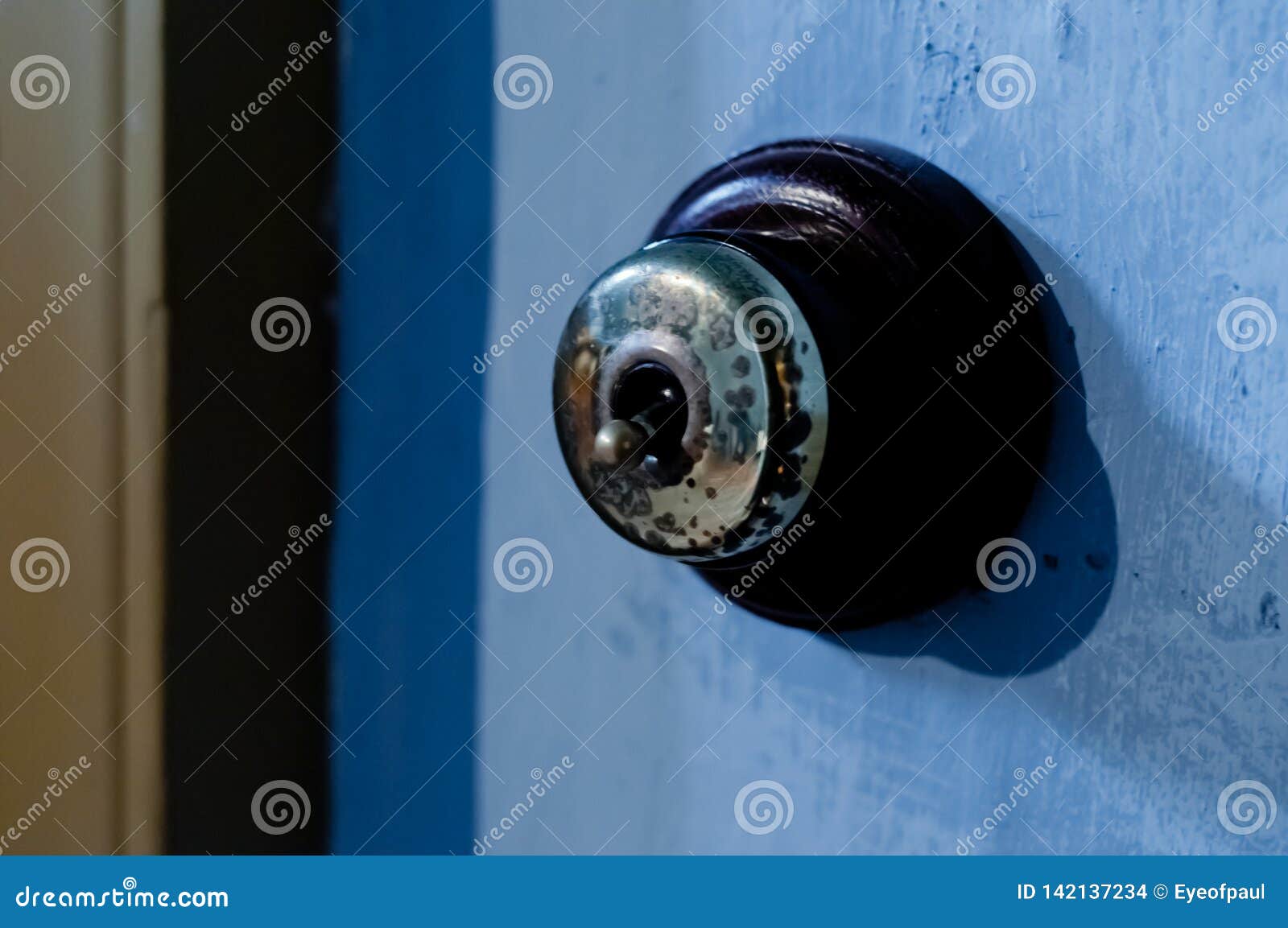 Brass Vintage Safety Electricity Flip Switch on a Wall Stock Photo