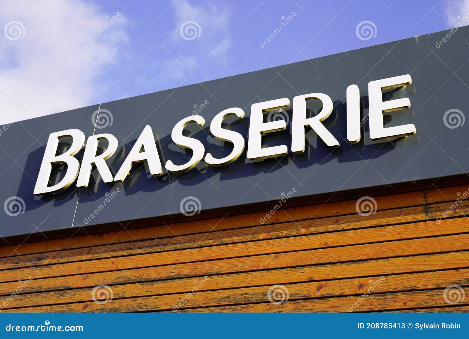 brasserie means beer bar sign text on pub a city street storefront building