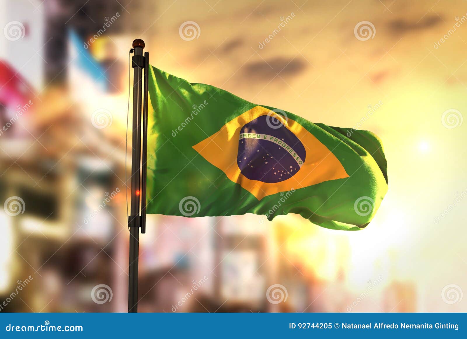 brazil flag against city blurred background at sunrise backlight