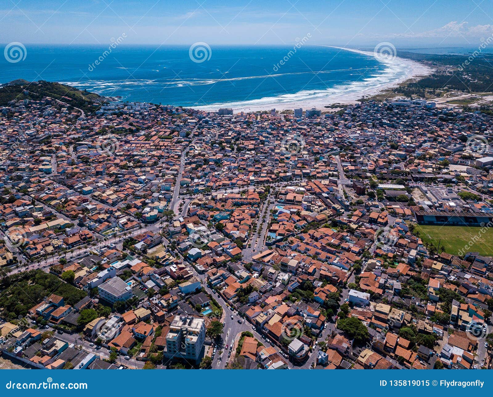 brazilian small beautiful city arraial do cabo . aerial drone photo from above city line. red roofs, narrow streets