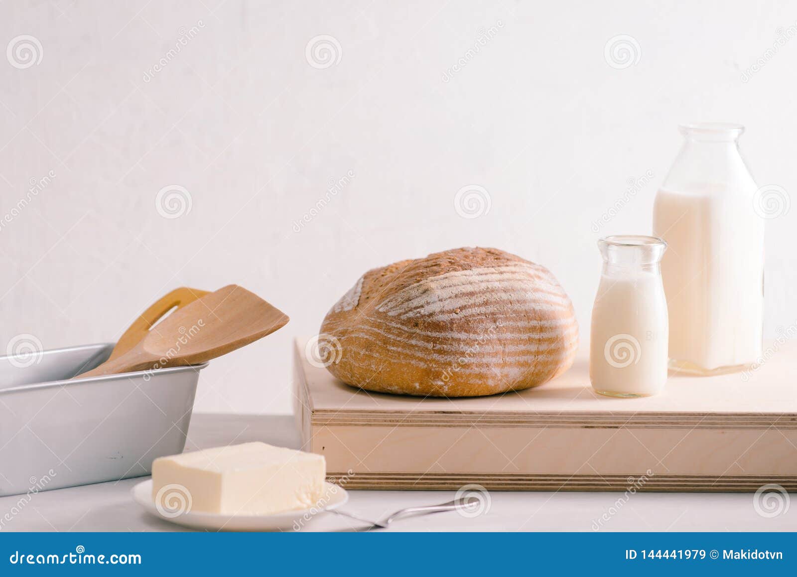 Bread Bake and Butter on Wooden Cutting Board. Simple Breakfast Stock
