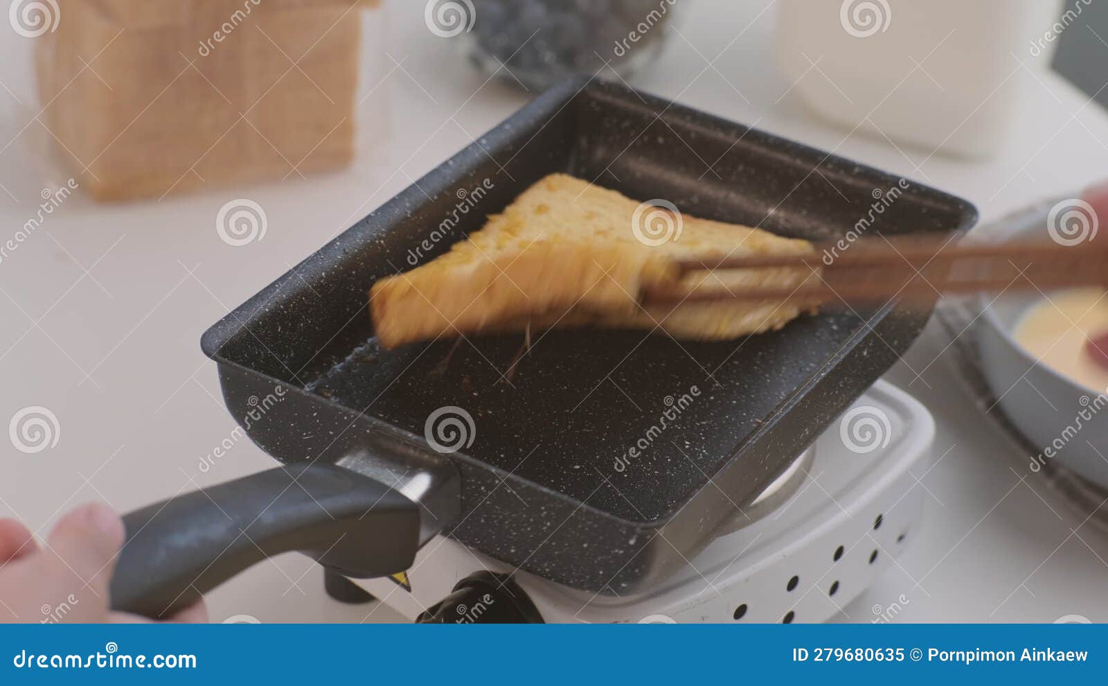 Bread Croutons in an Egg are Fried in a Pan. Closeup. Fried Bread