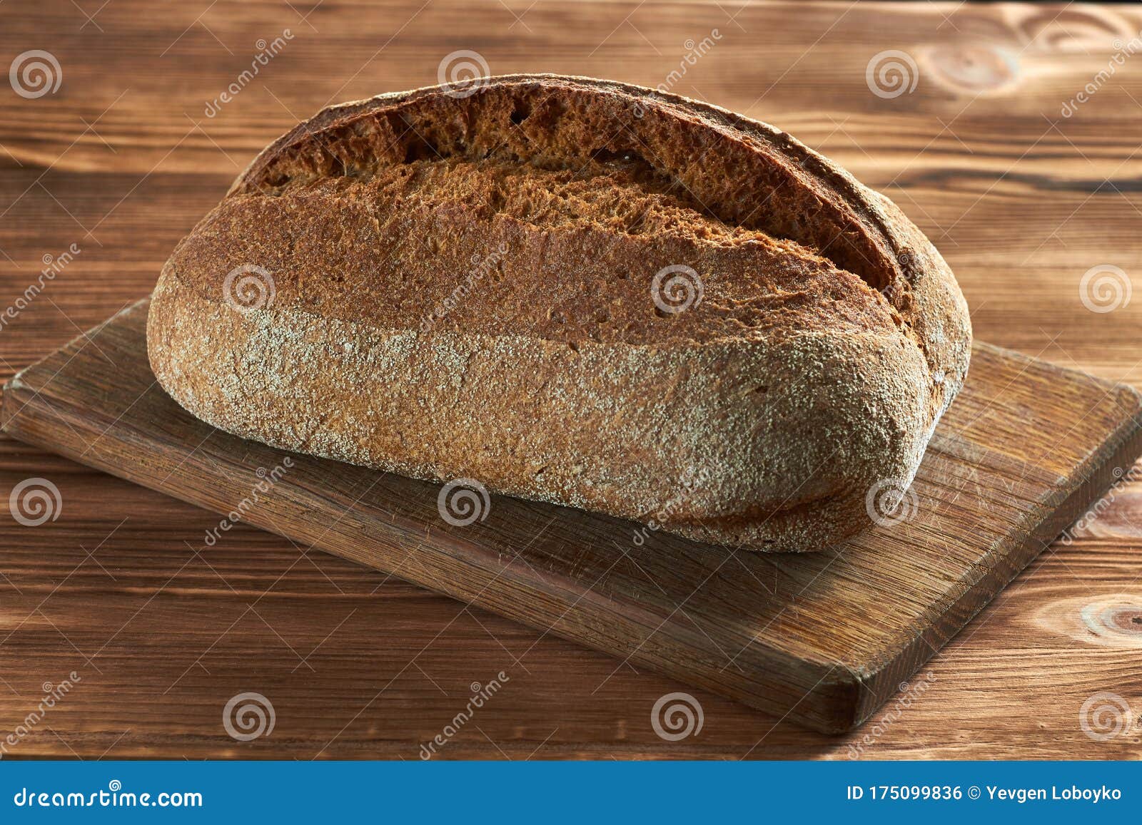 Bread on a cutting board stock photo. Image of grain 175099836