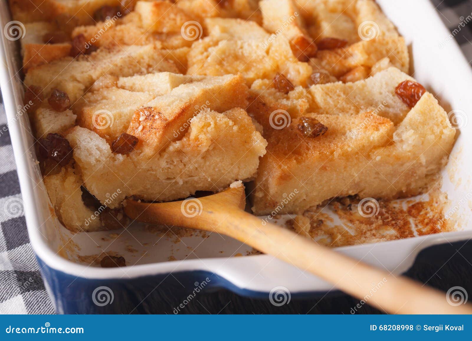 bread-pudding-with-raisins-macro-in-baking-dish-horizontal-stock-photo