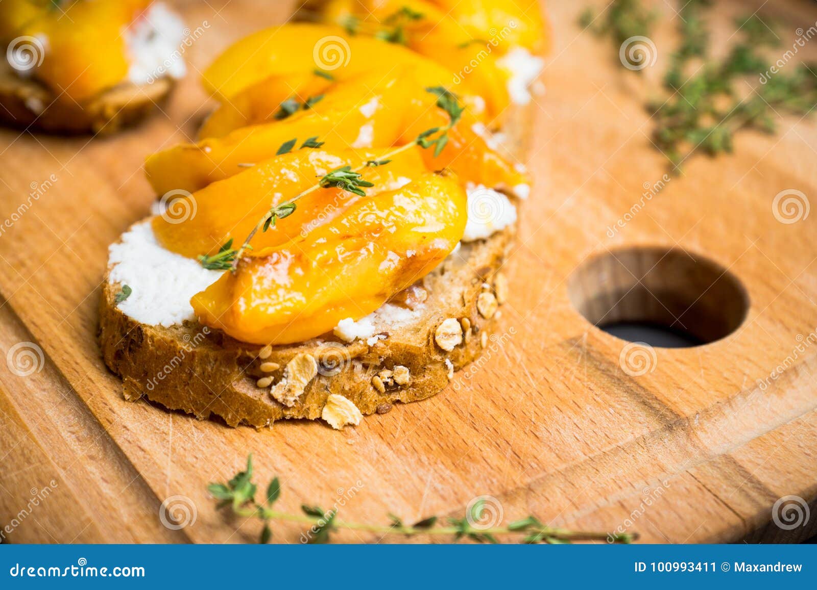 Bread with Ricotta Cheese and Grilled Peaches on the Rustic Background