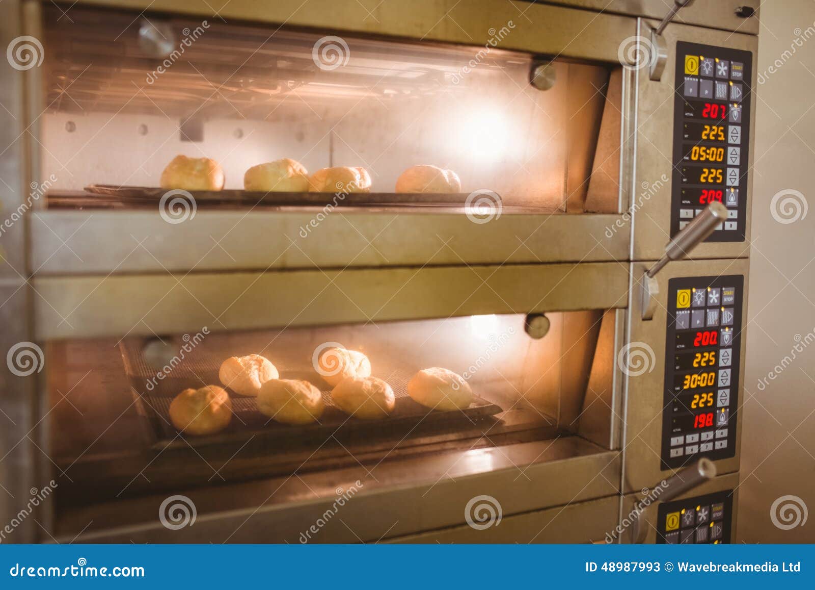 Bread rolls baking in oven stock image. Image of culinary 48987993