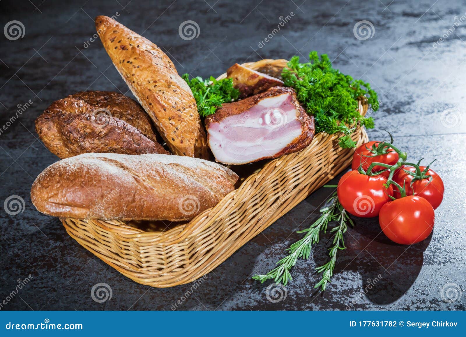 Bread and Smoked Meat in a Braided Basket on the Table. Stock Photo