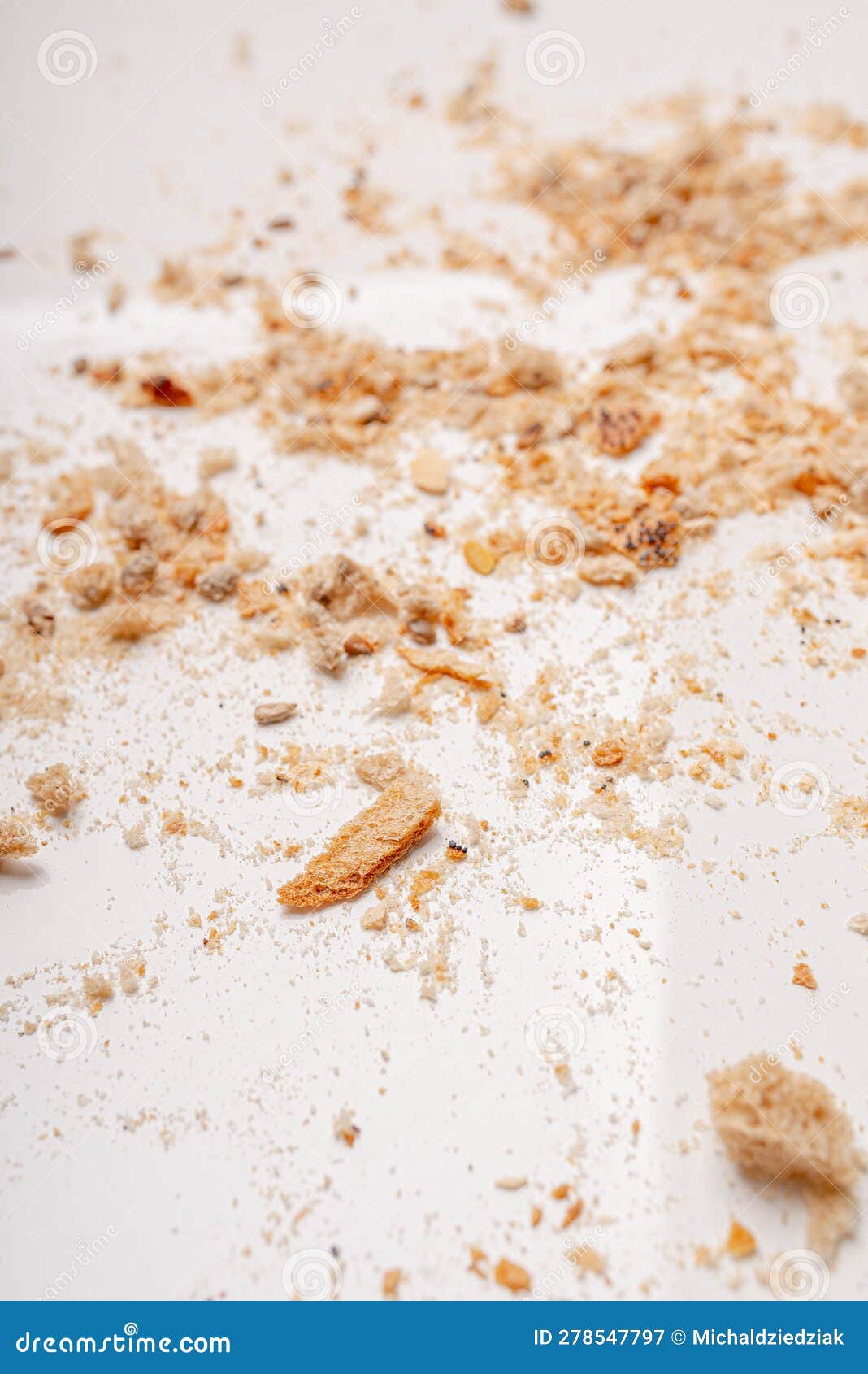Breadcrumbs Laying on White Table. Dried Bread Background Stock Image