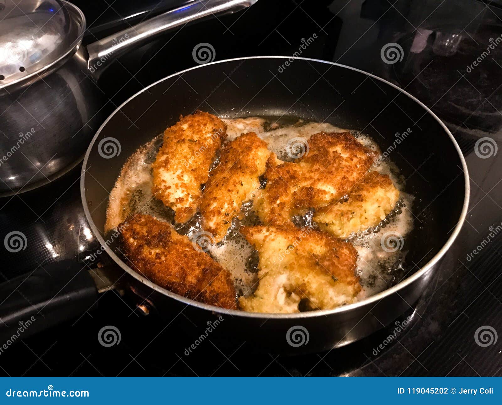 Breaded Chicken Cutlets Frying in a Pan Stock Photo - Image of cutlets