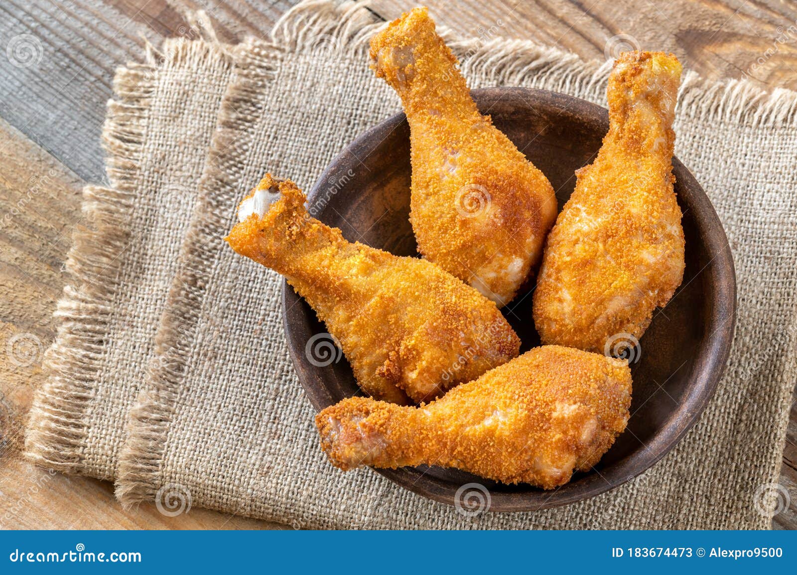 Breaded chicken drumsticks stock image. Image of bowl 183674473