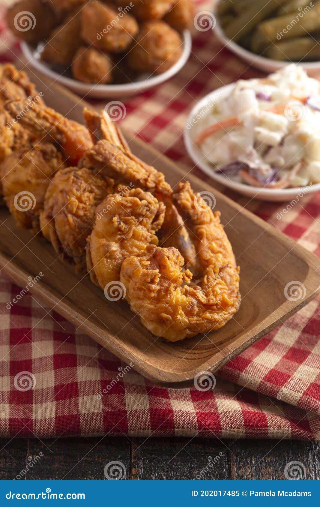 Breaded and Fried Jumbo Shrimp with Tails on a Wooden Table Stock Image