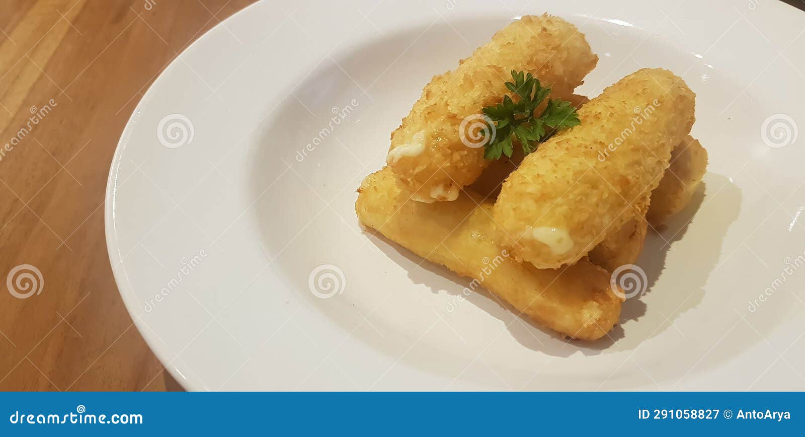 Breaded Fried Mozzarella Cheese Sticks Plated in White Plate Served As