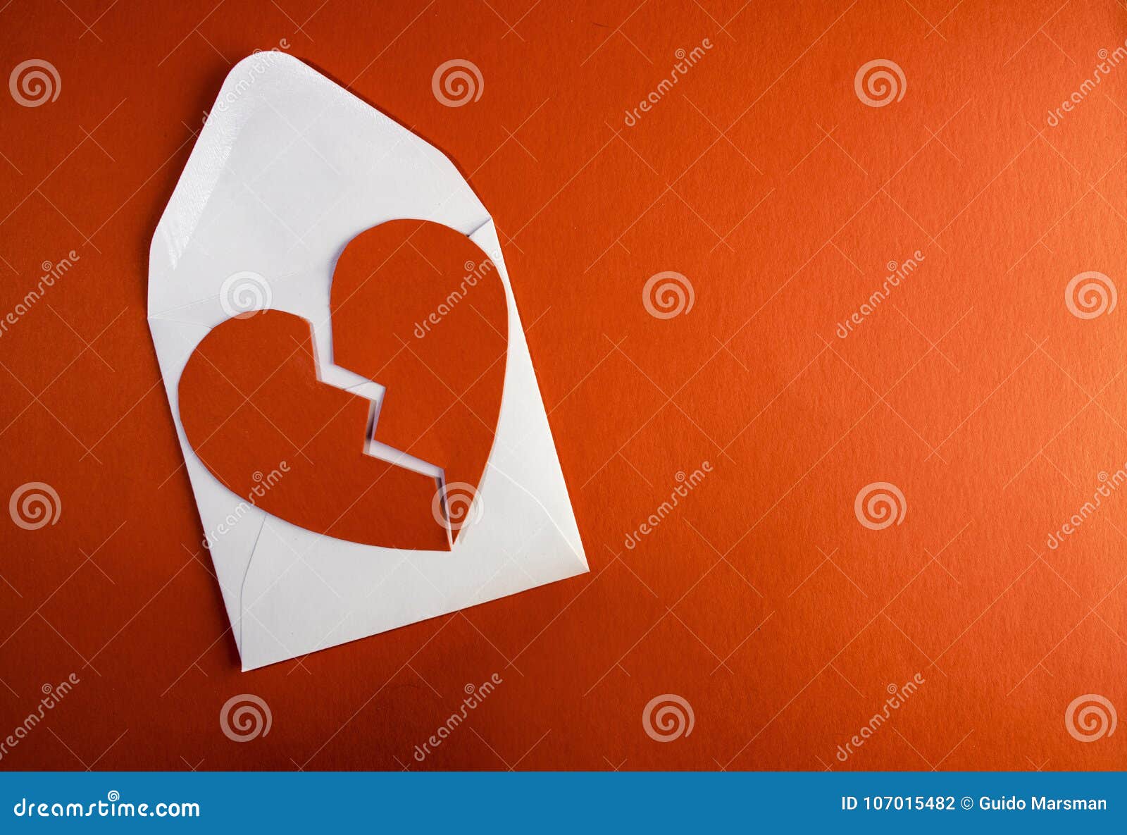 a break up envelope letter with a broken tore up paper heart