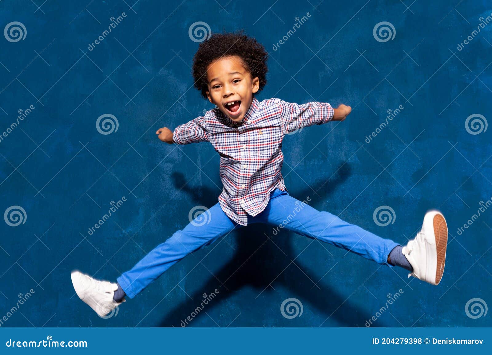 breakdancing joyful african american cute little child boy levitating in jump.