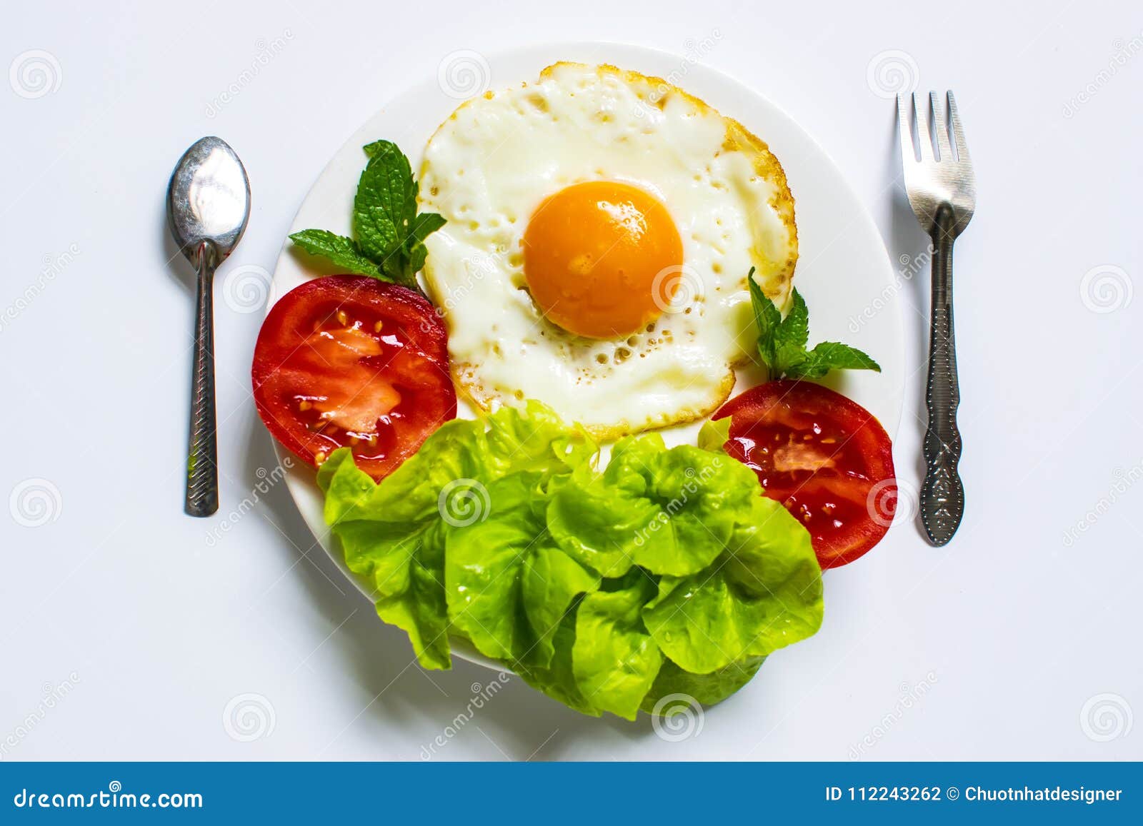Breakfast with Bread, Fried Eggs, Milk and Vegetables and Fried Tomato