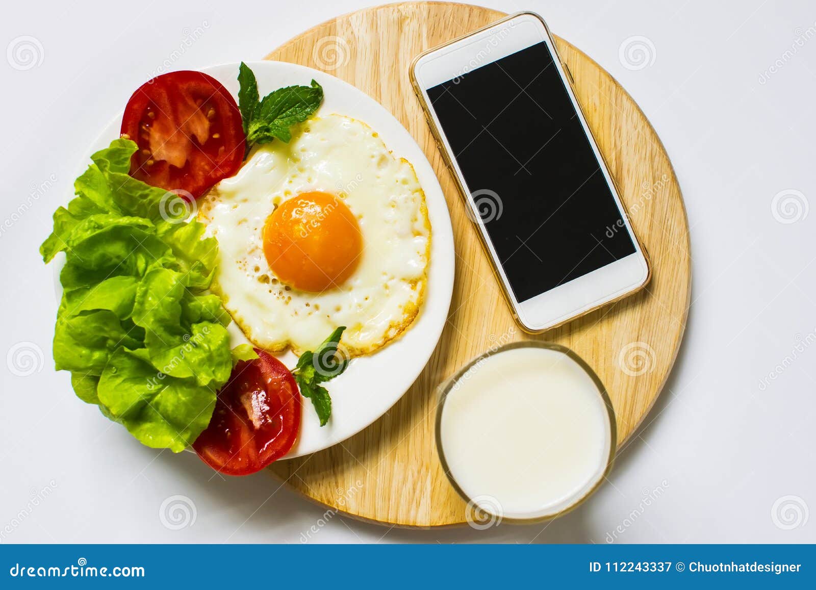 Breakfast with Bread, Fried Eggs, Milk and Vegetables and Fried Tomato