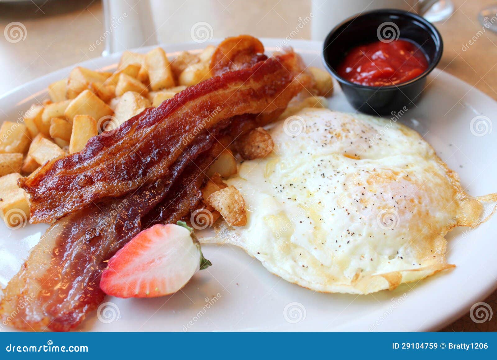Breakfast of Eggs,bacon and Hash Browns on a White Plate Stock Image