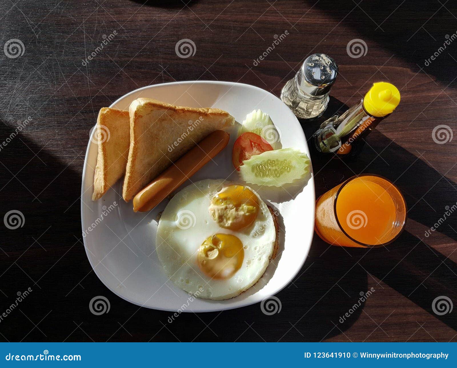 Breakfast with Eggs, Sausages, Bread with Orange Juice and Sauces Stock