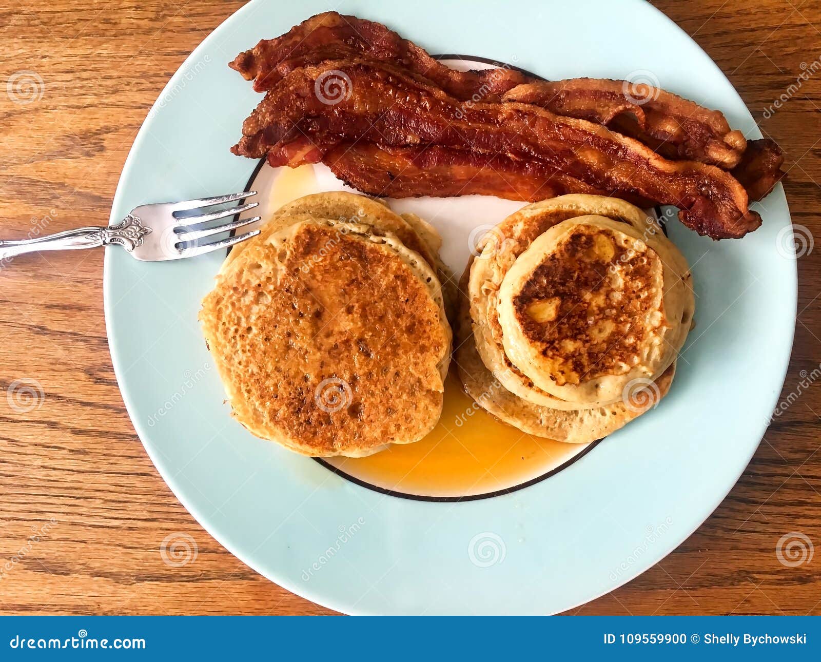 Breakfast of Stacks of Pancakes, Syrup, Bacon Strips, on a Plate with a