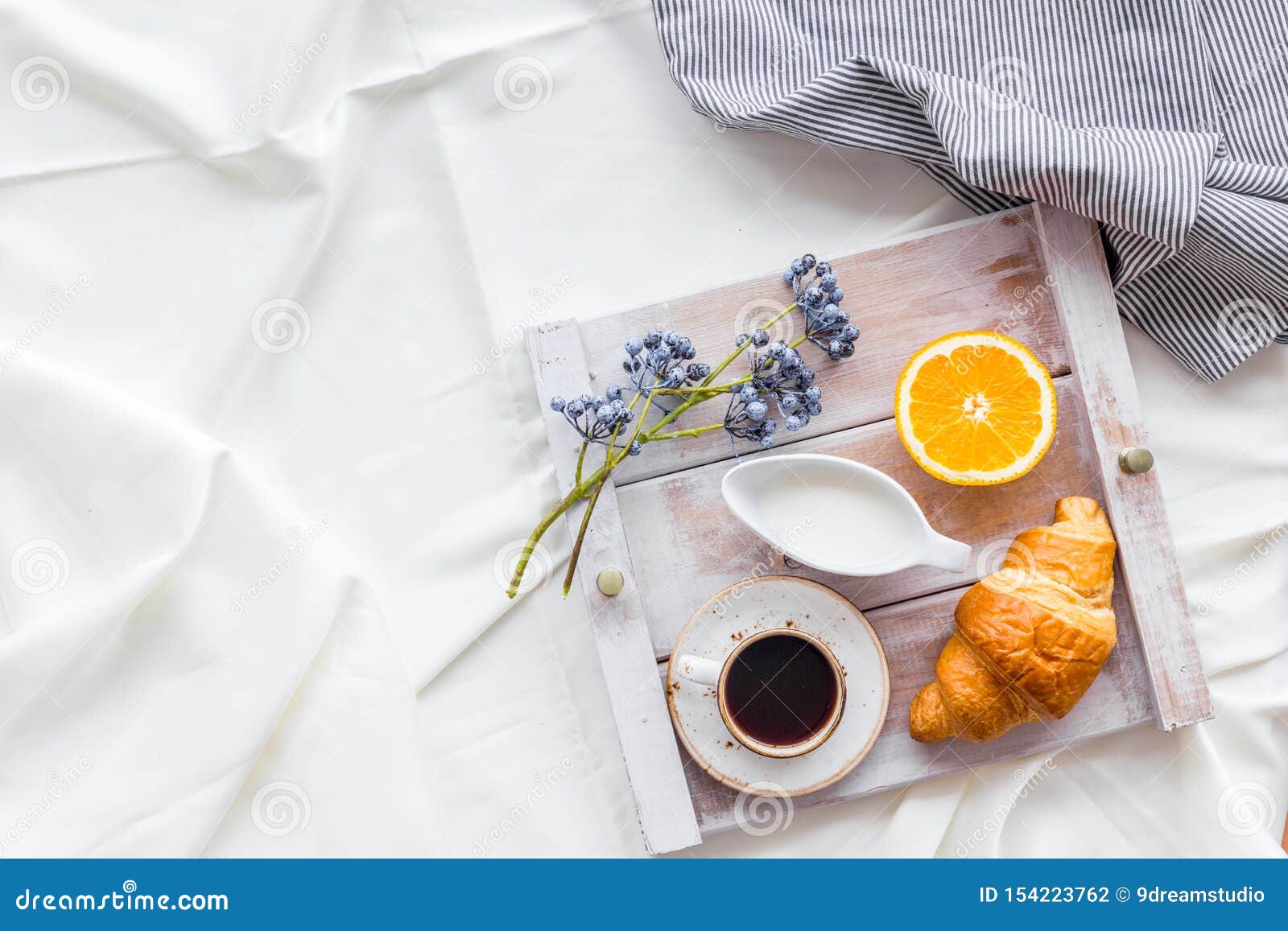 Download Breakfast On The Tray With Croissant, Coffee With Cream And Fruit On White Bed Sheet Background ...