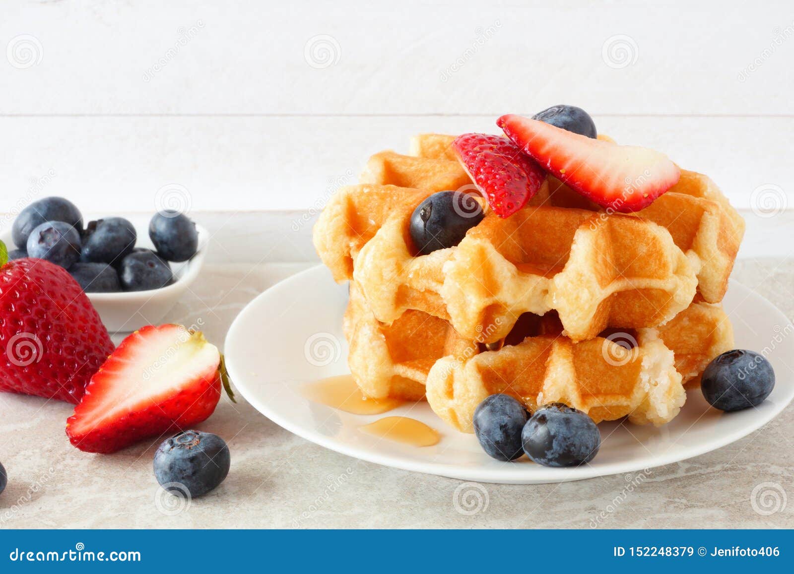 Breakfast Waffles with Syrup, Strawberries and Blueberries with a White
