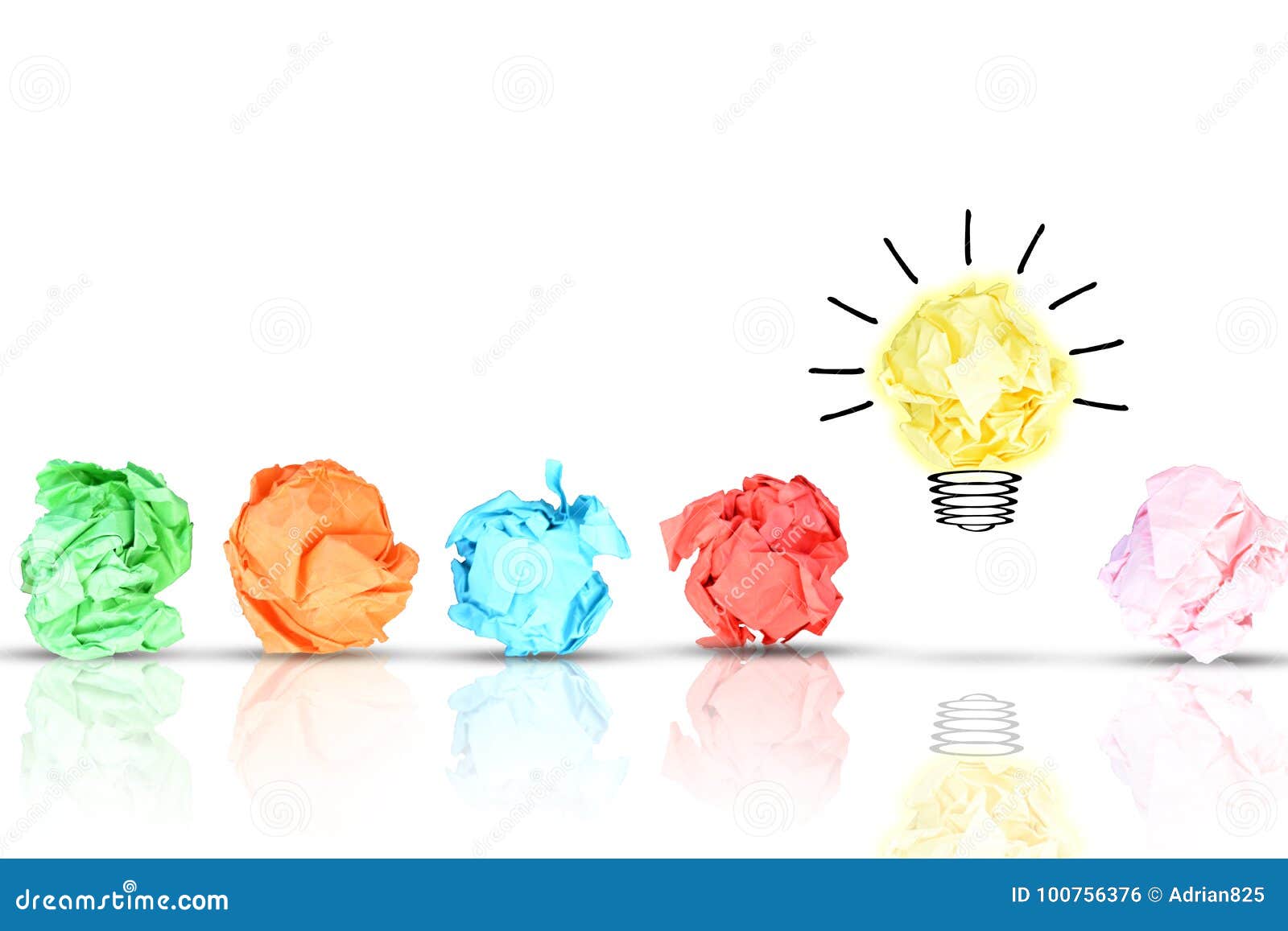 breakthrough concept with multiple colorful crumpled pieces of paper around a yellow bright light bulb d paper on white backg