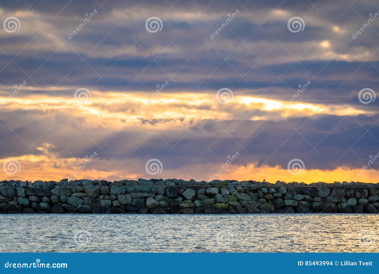breakwater and dramatic sky at lista in southern norway