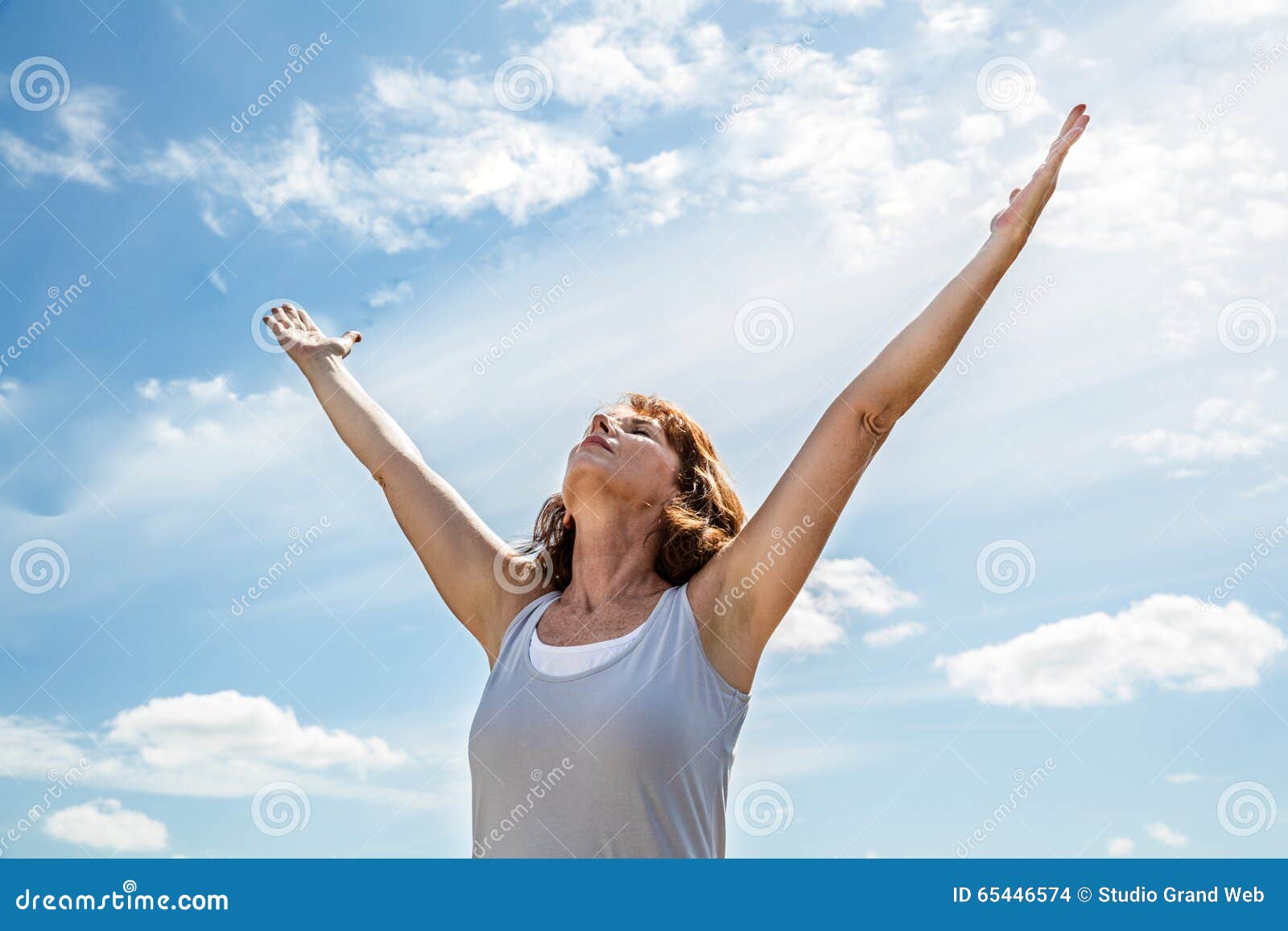 breathing outside for zen yoga woman raising her arms