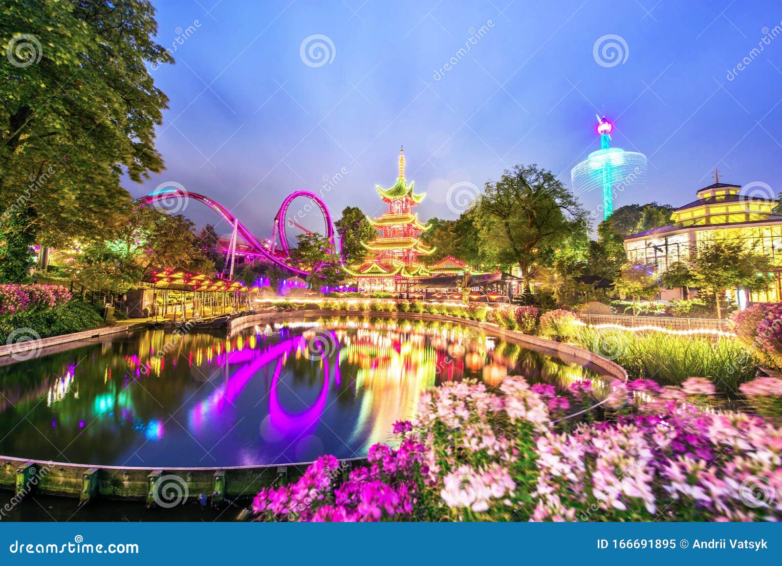 breathtaking magical landscape in tivoli gardens in the evening with lake and flowers. copenhagen, denmark. exotic amazing places
